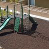 Playground with green slides on a mulch play area