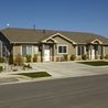 Home with lamp posts and a landscaped front yard